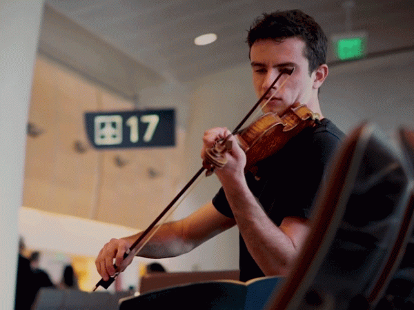 Ben and his violin at gate 17