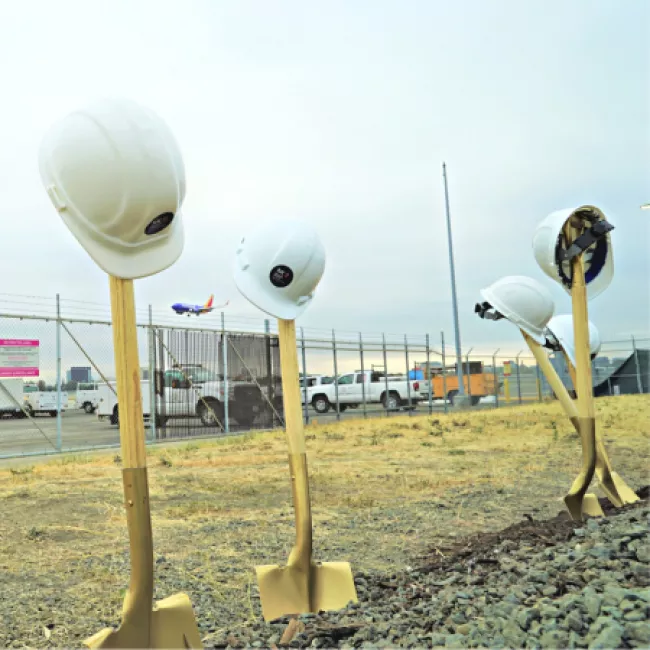 Shovels and helmets at groundbreaking ceremony.