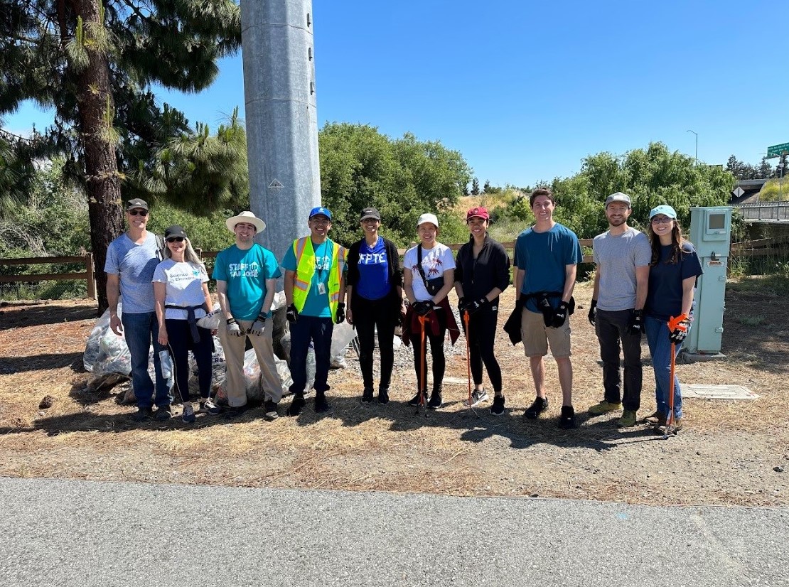 Airport employees and volunteers smile for a photo after cleaning up the river.